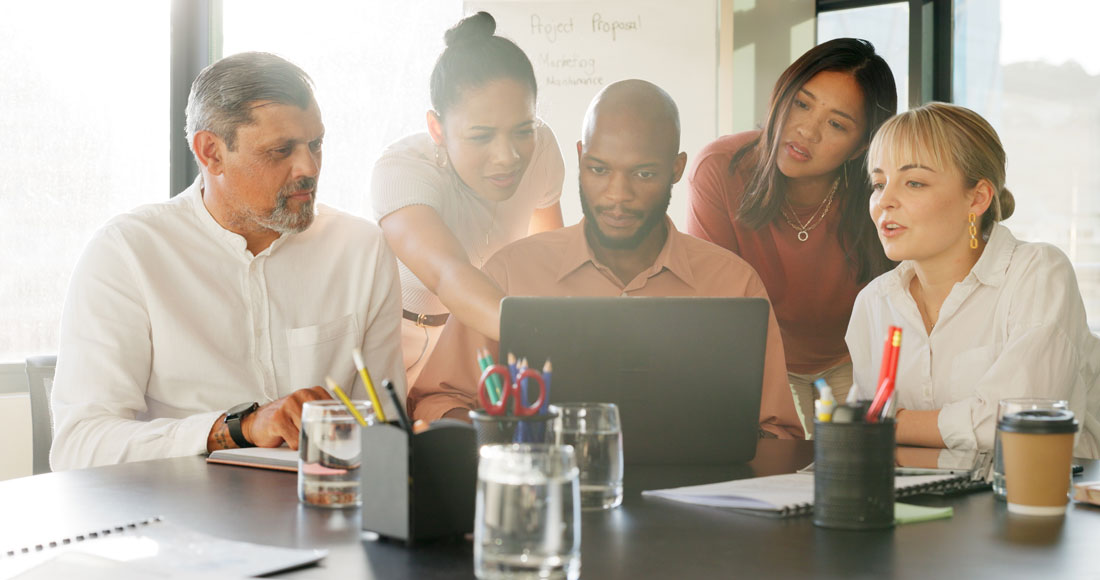 Group Employees Around Computer