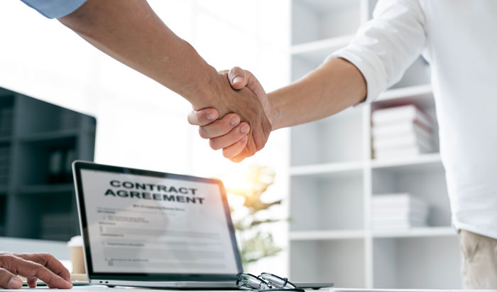 employee employer shaking hands in agreement