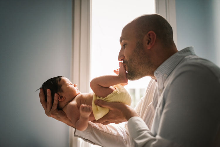 father with baby paternity leave